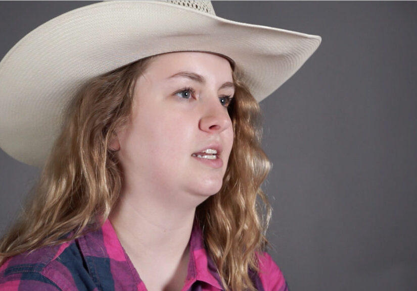 young woman with long hair wearing a cowboy hat